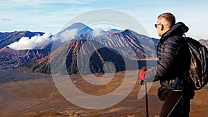 Traveler against fantastic sunrise on the Bromo volcano. Indonesia. Java island