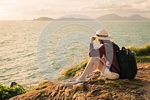 Traveler asia woman sitting on sea cliff