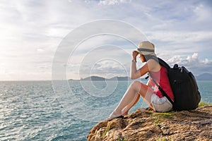 Traveler asia woman sitting on sea cliff