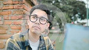 Traveler Asian man direction and looking on location map while spending holiday trip at Ayutthaya, Thailand, backpacker male enjoy