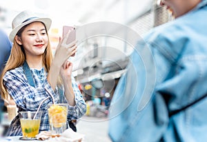 Traveler Asian woman friend travel in Bangkok, Thailand, sweet couple taking photo . Lifestyle couple travel in city concept.Young