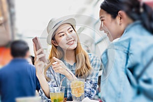 Traveler Asian woman friend travel in Bangkok, Thailand, sweet couple taking photo . Lifestyle couple travel in city concept.Young