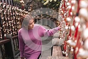 Traveler asian woman look  the gold bells of wish wall on Wenwu Temple, Taiwan