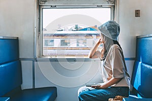 Traveler asian woman with mobile phone travel by train in Thailand