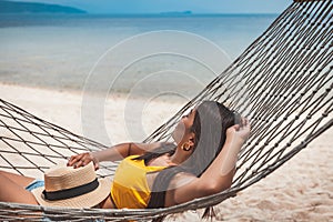 Traveler asian woman relax and travel in hammock on summer beach at Koh Rap Samui in Surat Thani Thailand