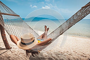 Traveler asian woman relax and travel in hammock on summer beach at Koh Rap Samui in Surat Thani Thailand