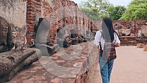 Traveler Asian woman spending holiday trip at Ayutthaya, Thailand, Japanese backpacker female enjoy her journey at amazing