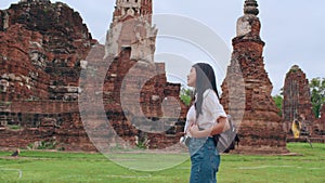 Traveler Asian woman spending holiday trip at Ayutthaya, Thailand, Japanese backpacker female enjoy her journey at amazing