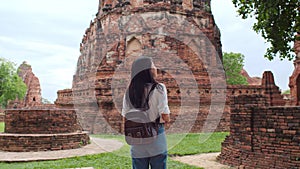 Traveler Asian woman spending holiday trip at Ayutthaya, Thailand, Japanese backpacker female enjoy her journey at amazing