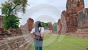 Traveler Asian woman spending holiday trip at Ayutthaya, Thailand, Japanese backpacker female enjoy her journey at amazing