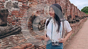 Traveler Asian woman spending holiday trip at Ayutthaya, Thailand, Japanese backpacker female enjoy her journey at amazing