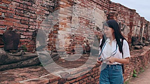 Traveler Asian woman spending holiday trip at Ayutthaya, Thailand, Japanese backpacker female enjoy her journey at amazing