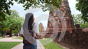 Traveler Asian woman spending holiday trip at Ayutthaya, Thailand, Japanese backpacker female enjoy her journey at amazing