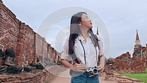 Traveler Asian woman spending holiday trip at Ayutthaya, Thailand, Japanese backpacker female enjoy her journey at amazing