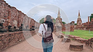 Traveler Asian woman spending holiday trip at Ayutthaya, Thailand, Japanese backpacker female enjoy her journey at amazing