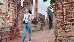 Traveler Asian woman spending holiday trip at Ayutthaya, Thailand, Japanese backpacker female enjoy her journey at amazing