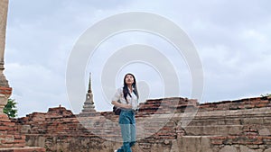 Traveler Asian woman spending holiday trip at Ayutthaya, Thailand, Japanese backpacker female enjoy her journey at amazing