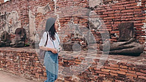 Traveler Asian woman spending holiday trip at Ayutthaya, Thailand, Japanese backpacker female enjoy her journey at amazing