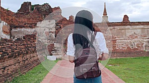 Traveler Asian woman spending holiday trip at Ayutthaya, Thailand, Japanese backpacker female enjoy her journey at amazing