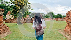 Traveler Asian woman spending holiday trip at Ayutthaya, Thailand, Japanese backpacker female enjoy her journey at amazing