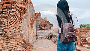 Traveler Asian woman spending holiday trip at Ayutthaya, Thailand, Japanese backpacker female enjoy her journey at amazing