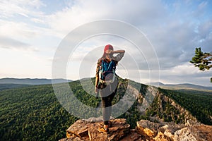 Traveler on the background of the mountain, rear view. A woman is traveling in Bashkiria, Russia. Mountain tourism in Russia.