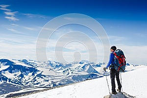 Traveler with backpack and mountain panorama