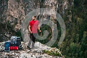 A traveler with a backpack in the mountains. A man with a backpack. The concept of a hiking lifestyle. Hiking in the mountains