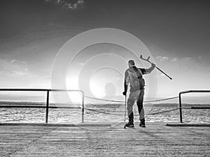 Traveler with backpack walk dificult with medicine poles