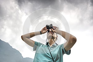 Traveler with binoculars in Sapa Valley