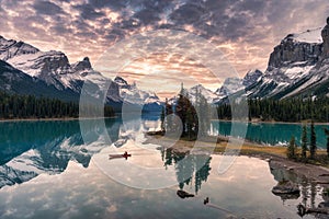 Traveler canoeing with rocky mountain reflection on Maligne lake at Spirit island in Jasper national park