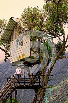 Traveler Caucasian woman visiting Casa del Arbol, Ecuador