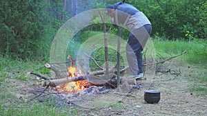 The traveler chop wood to make fire and cook food 4k