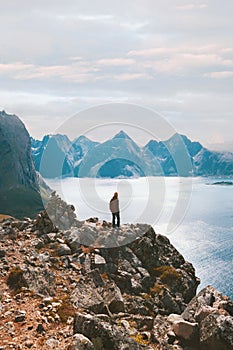 Traveler on cliff in Norway hiking solo Travel adventure active vacations outdoor healthy lifestyle