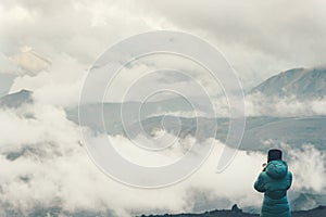 Traveler climbing enjoying cloudy foggy mountains