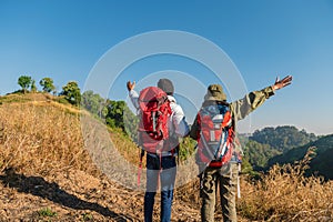 traveler couple with backpack standing looking view on mountain