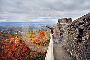 Traveler couple at city wall in Signagi