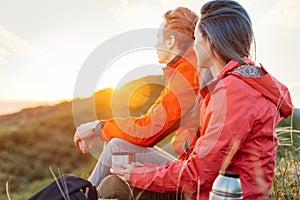 Traveler couple resting with cup of tea outdoor.