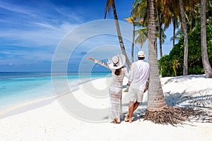 Traveler couple stands on a beautiful, tropical beach