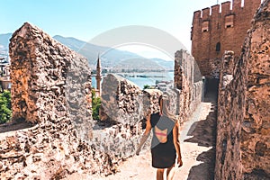 Traveler exploring the city of Alanya in Turkey. Woman walking and discovering old landmark in Europe. photo