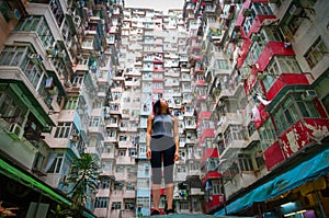 Traveler Exploring Densely Populated Housing Apartments in Hong Kong photo