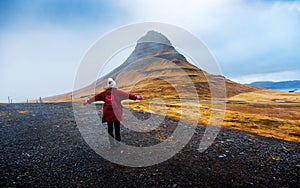 Traveler at famous Kirkjufellsfoss waterfall in Iceland