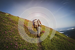 Traveler, female going up on the mountain trail