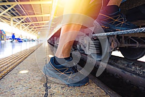 Traveler getting on a train ; close up view of shoes