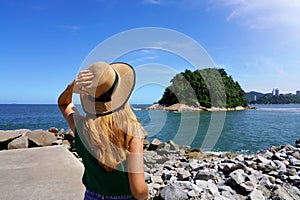 Traveler girl looking the uninhabited Urubuquecaba Island near Santos coast, Baixada Santista, Brazil photo