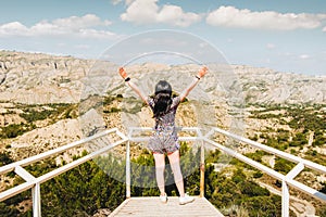 Traveler girl with open arms enjoying beautiful landscape of VAShlovani national park in Georgia. Famous travel destination.