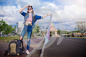 Traveler girl`s and big bags standing on street and looking for