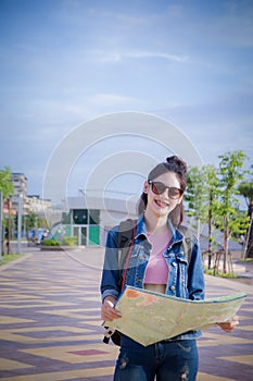 Traveler girl`s hold a map and looking for destination