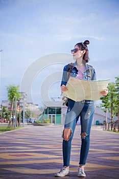 Traveler girl`s hold a map and looking for destination