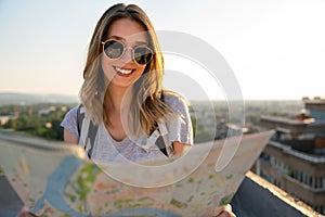 Traveler girl searching right direction on map, travel, freedom and active lifestyle concept